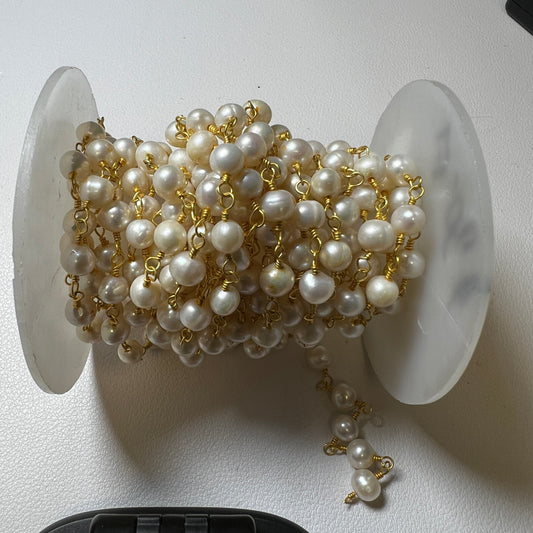 Pearls on gold finished wire.  6 millimeters